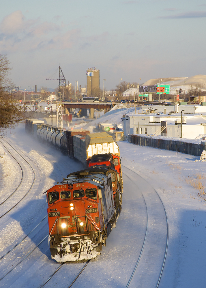 it's about fourty minutes before sunset as CN 2407 leads a short version of CN 401 (just 43 cars in tow) as it passes through Turcot West.