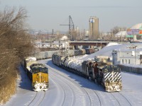 <b>Lucky timing.</b> I couldn't have gotten any luckier with my timing here, as CN 543 at left (with CSXT 3224 & CSX 468 for power) is backing up at Turcot West, just as CN 323 passes at right, with BCOL 4649, CN 2599, BCOL 4643 and only 22 cars.