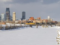 With a large amount of clouds behind the train but a clear blue sky behind me, a 46-car long CN 528 is crossing the Lachine Canal with NS 7538, NS 1042, UP 4615 & NS 9069 for power. Very barely visible in the distance at far left is the noodle on CN's headquarters in downtown Montreal.
