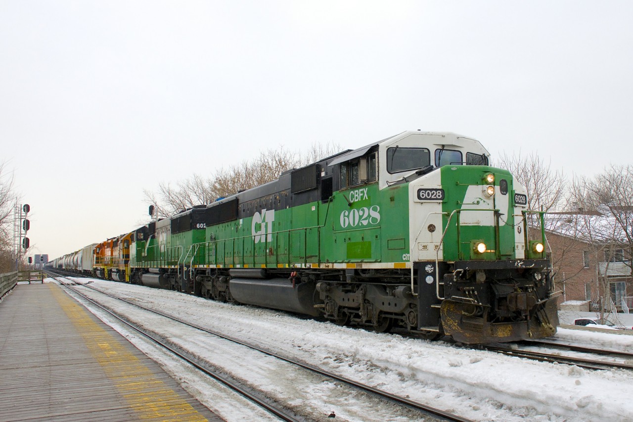 Two ex-BNSF SD60M's (CBFX 6028 & CBFX 6029) are leading QGRY 3105 & SLR 3035 as detour SLR 393 passes Lasalle station on a gloomy morning. The St. Lawrence & Atlantic Railroad has found themselves power short due to these detours and has leased three ex-BNSF SD60M's. This is the first time one leads into Montreal.