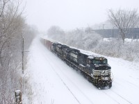 With two units (NS 9458 & NS 1045) and only 38 cars, CN 528 is really flying as it heads east on a snowy afternoon.