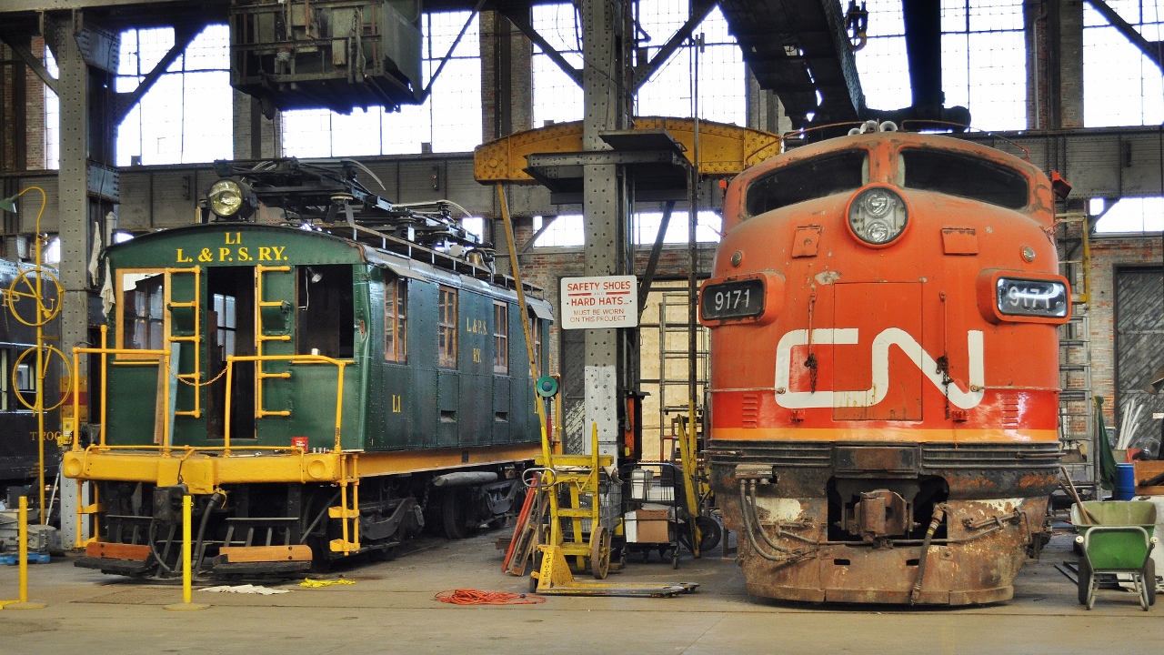 33 years separates unlikely neighbours at the Elgin County Railway Museum,


 ex L&PS Motor L1 (GE March 1915) 


and ex CN 9171 (ex GTW 9013 F3Au, EMD May 1948); 


L1 in process of some needed TLC. 


August 31, 2012 digital by S.Danko