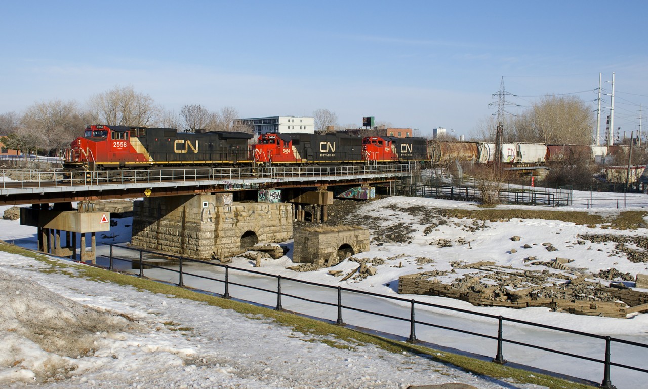 CN 527 with CN 2558, CN 5464 & CN 9584 slowly advances over the Lachine Canal before backing up as it works on its set-off and then lift at Pointe St-Charles Yard. A snowbank gives me some elevation on this spring-like afternoon.