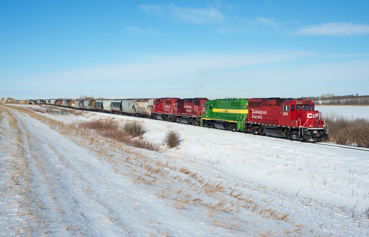 A CP grain peddler makes its way down the Macklin Sub just east of Primate Saskatchewan. Second out in the consist is RTEX 4996 a GP38-3 bound for a crude oil terminal near Kerrobert.