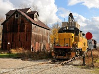 An eventful Halloween of chasing the Goderich and Exeter subdivisions showcased the pinnacle of fall weather. Sun, rain and snow showers. With the temperature hovering around the freezing mark and a brisk wind blowing off Lake Huron GEXR had a "record" train length for the Exeter sub. After working Clinton and Hensall, the crew with RLK 2211 and LLPX 2236 headed south to the end of track with 17 cars for P&H in Centralia. Not a common practice to see that many cars destined for P&H at one time would result in some extra work for the crew to get the cars on the right end of the engine to spot, with the only available siding to run around the cars at a capacity of 9 car lengths. The crew would essentially have to run around the train twice, with a push-pull operation taking place in the middle of their moves. The longer siding onsite was taken out of service years ago and can been seen rusting in the weeds beside the old feed mill. Here the units are captured nosing out the north end of the "9 car siding" after making their final run around move to spot cars to the elevator. This part of the line has since been embargoed, with freights no longer running south of Exeter.