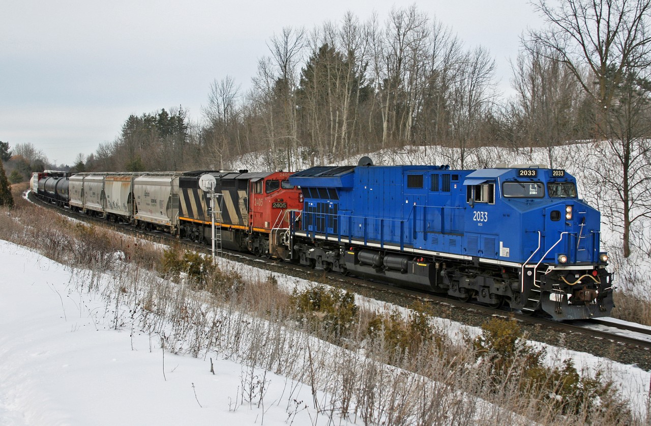 M 32241 11 splits the signals at Mile 30 on the Halton Sub, with a leased GECX locomotive in the lead.  M 322 is an as required, Winnipeg to Battle Creek detour train, which operated across Northern Ontario, as opposed to operating south out of Winnipeg and through Chicago.  Power was: GECX 2033, CN 2405 and CN 8933 was the mid train DP unit.