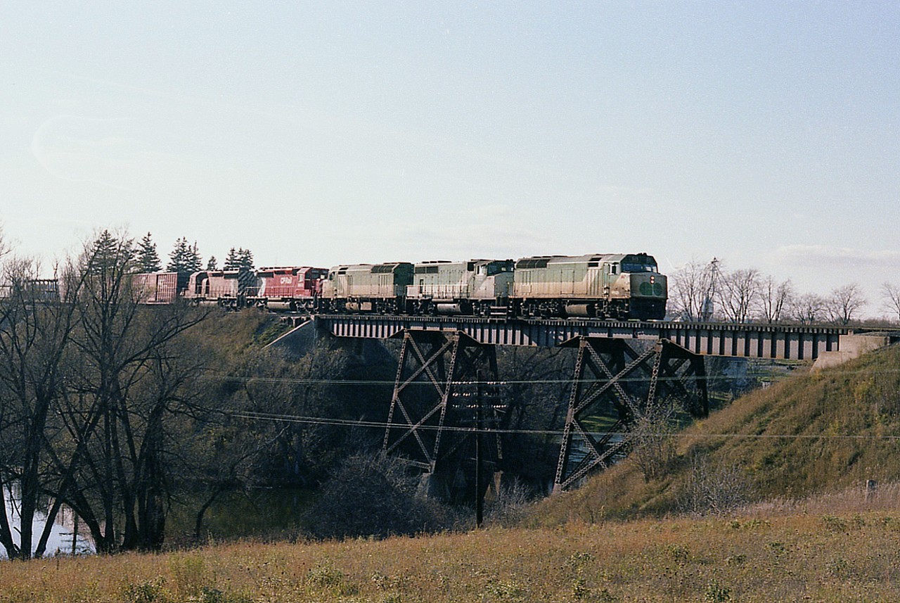 Sitting over on the east side of the river bridge at Thamesford on a nice afternoon, it was a bummer that eastbound #904 was running a little late. As in close to sundown.  The longer the wait, the worse the sun angle. But at least the scene was captured; borrowed GO 515, 703 and 513 lead CP 5993 and 5902 back to Toronto, where the GO units must be returned from their weekend freight service to regular weekday commuter operations. Both CP and CN borrowed GO power back around this time, as due to an upswing in freight traffic they were both running power short.