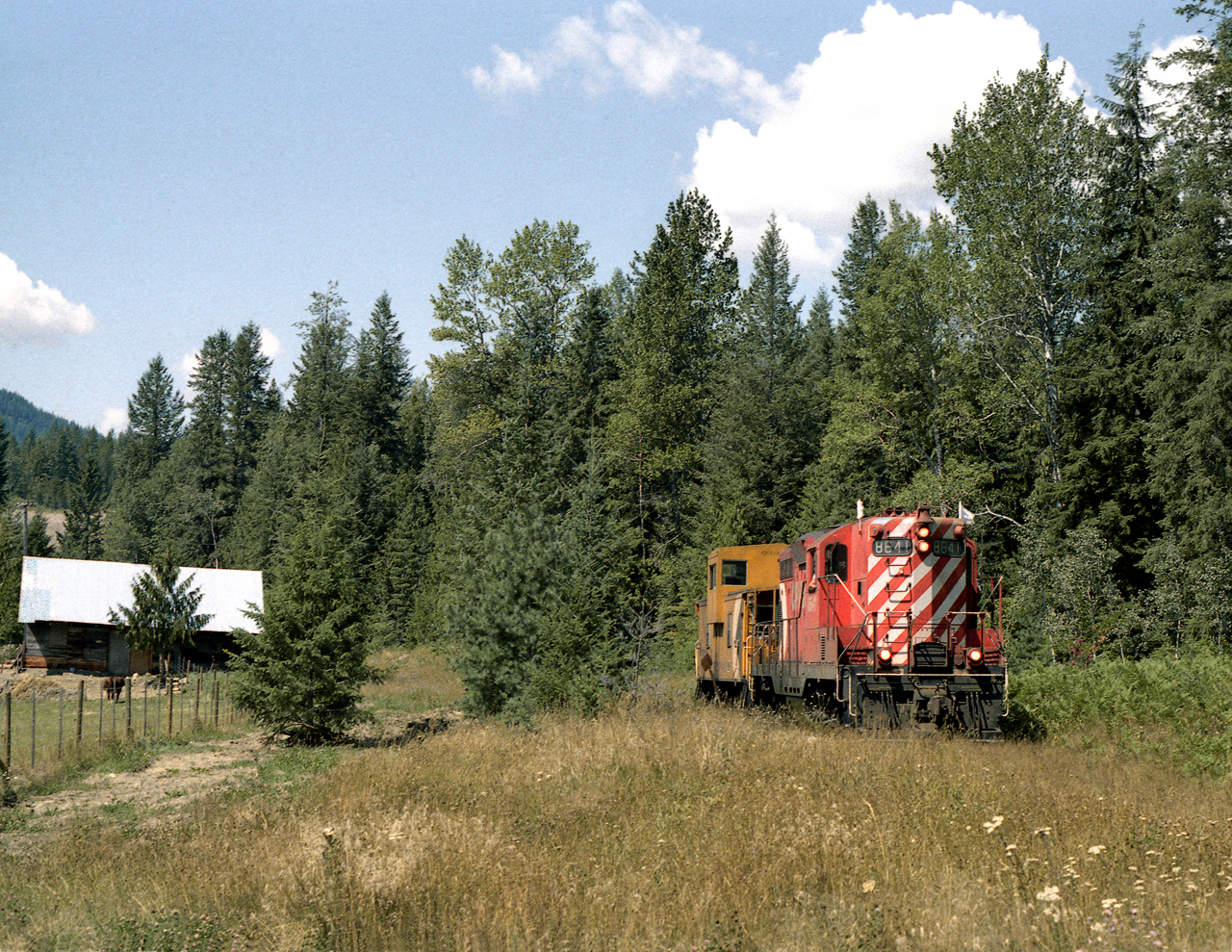 Work train assigned to tie gang working near Nakusp on the isolated Kaslo Subdivision heads to the barge terminal at Rosebery to pick up cars of treated ties.