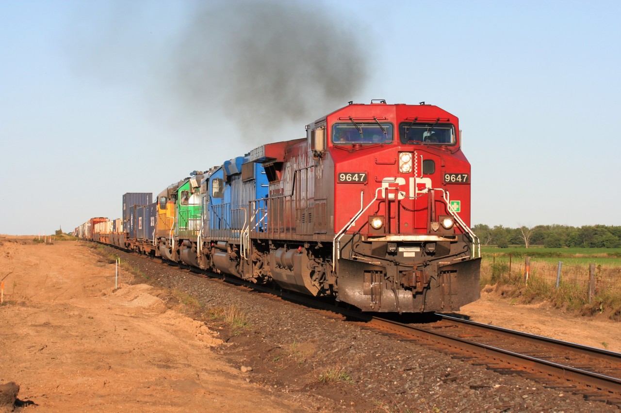 With the new Wolverton, Ontario yard under construction, CP AC4400CW 9647 leads train 245 as it accelerates westward out of Wolverton siding with three leased locomotives of various paint schemes trailing. Note, at this time, Wolverton was not CTC yet and the new yard was in the beginning stages of being constructed.