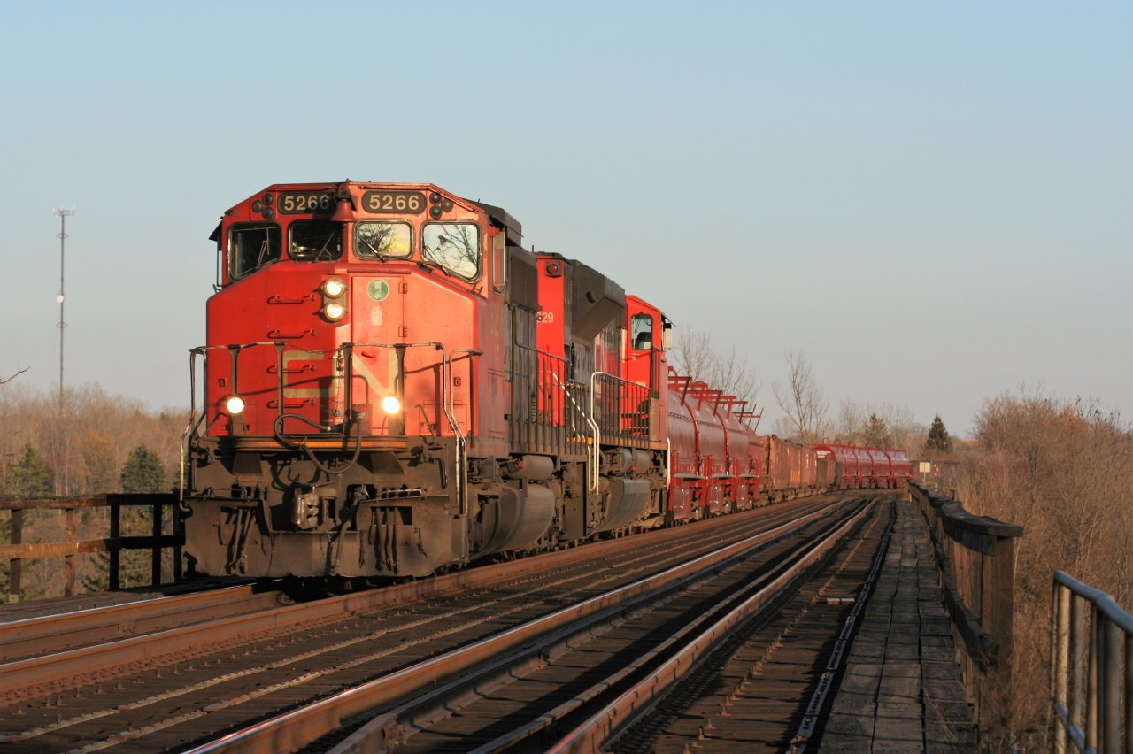 CN train 331 is seen crossing the Grand River trestle in Paris, Ontario with SD40-2(W) 5266 and SD70M-2 8829 as they chase the setting sun towards London on the Dundas Subdivision.