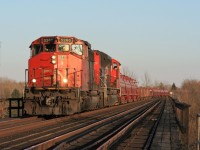 CN train 331 is seen crossing the Grand River trestle in Paris, Ontario with SD40-2(W) 5266 and SD70M-2 8829 as they chase the setting sun towards London on the Dundas Subdivision. 