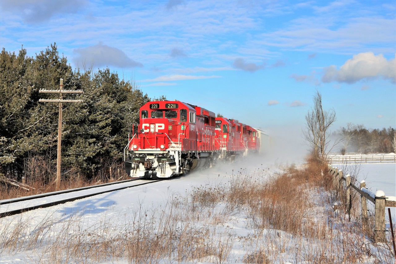 After getting a clearance from Guelph Junction, T69 kicks up the snow as it powers its way up to the Milburough Line and the Mountsberg Conservation area led by a nice clean CP 2211.