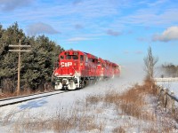 After getting a clearance from Guelph Junction, T69 kicks up the snow as it powers its way up to the Milburough Line and the Mountsberg Conservation area led by a nice clean CP 2211.