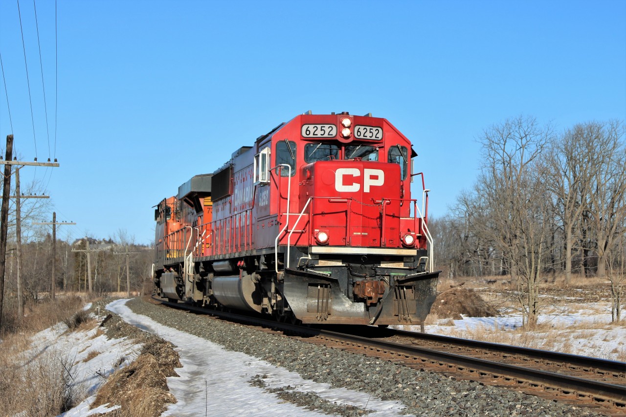 On a beautiful bright clear day, CP 147 with a nice clean SD60 in CP 6252, runs light power with BNSF 7339 approaches the Victoria Road crossing on their way to Wolverton.