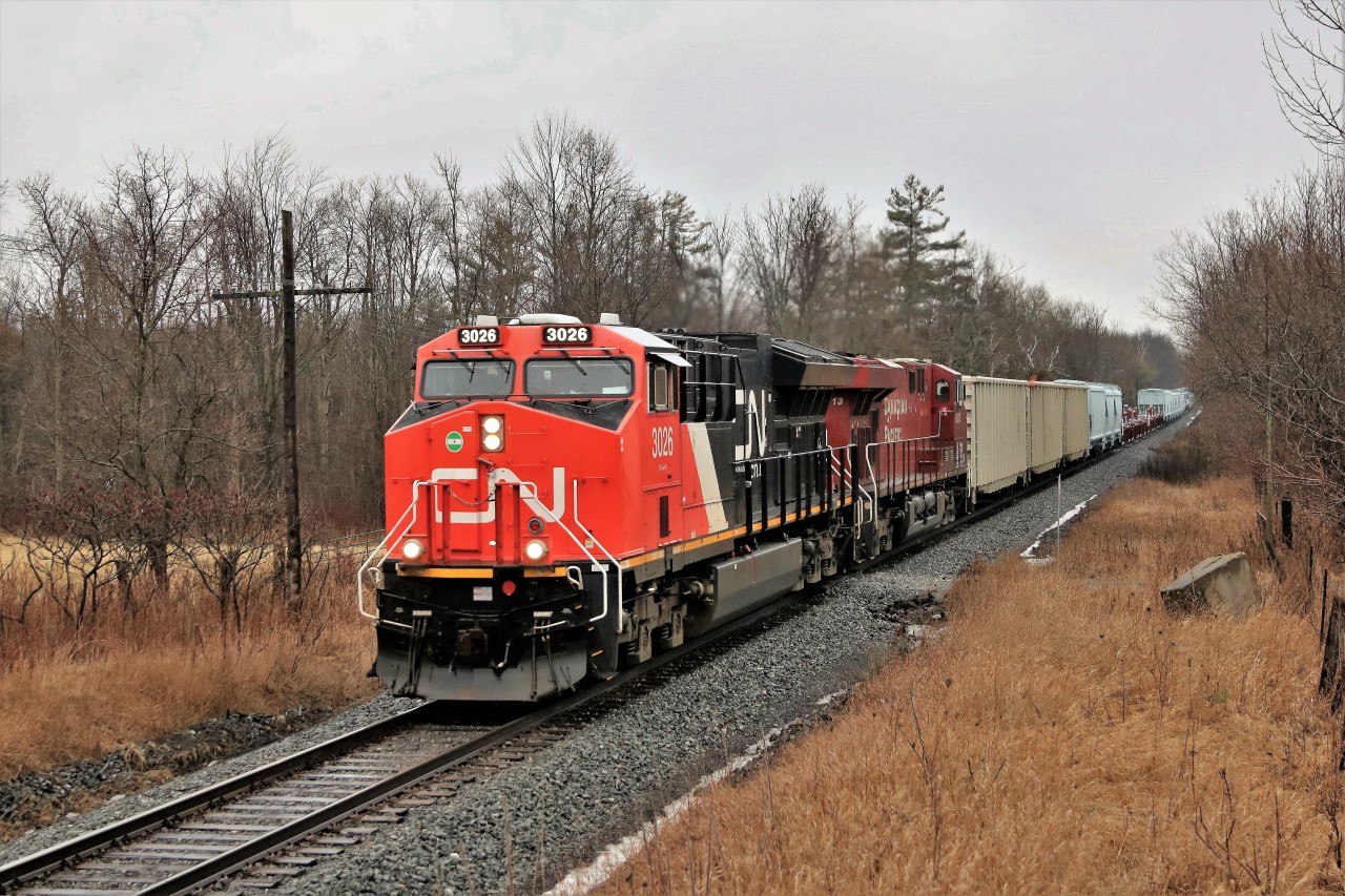 This power has been running up and down the Galt and Hamilton sub for some time now on CP 254 with the CP 8813 leading eastbound and south bound and CP 255 with this CN 3026 leading the return trip north and westward. With the days lengthening and CP 255 running early, the return trip finally came before dark. The light drizzle didn't help me but it did make the colours better.