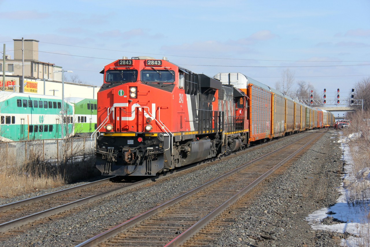 CN 271 heads west past a CN work crew at Georgetown Station. The old and new of CN power is evident on this train: CN 2843 leading a ratty-looking CN 4730.