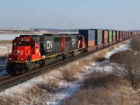 A matching set of CN former Oakway SD60's is in charge of the Valentine Day intermodal train #148 as it heads into Milton, with another train hot on its block.