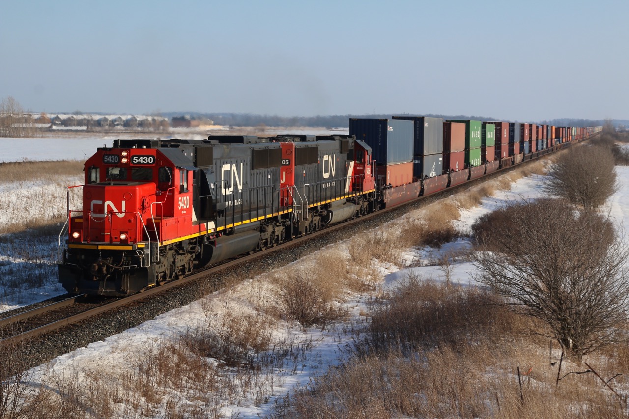 A matching set of CN former Oakway SD60's is in charge of the Valentine Day intermodal train #148 as it heads into Milton, with another train hot on its block.