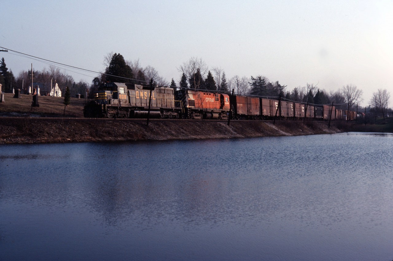 An eastbound CP Rail freight moves through Campbellville behind leased QNSL SD40 205 (later acquired by CP) and C424 4240) in the spring of 1985.