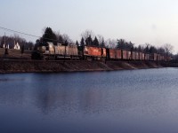 An eastbound CP Rail freight moves through Campbellville behind leased QNSL SD40 205 (later acquired by CP) and C424 4240) in the spring of 1985.