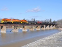 RLHH 2081, RLHH 3404, and RLHH 2111 lead a 96 car 597 (47 steel coil cars followed by 47 tanks) over the Grand River in Caledonia, ON