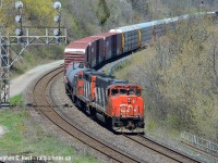 Due to brush cutting for the triple tracking project (which is still ongoing) angles not open for decades before suddenly opened up, and CN Train 554 is rounding the curve westbound of the Oakville subdivision at Bayview with cars for Hamilton in the mid afternoon. This is near the memorial on the east side of the York Rd bridge for those looking to find this angle. It should still be open today but I have not tried again.