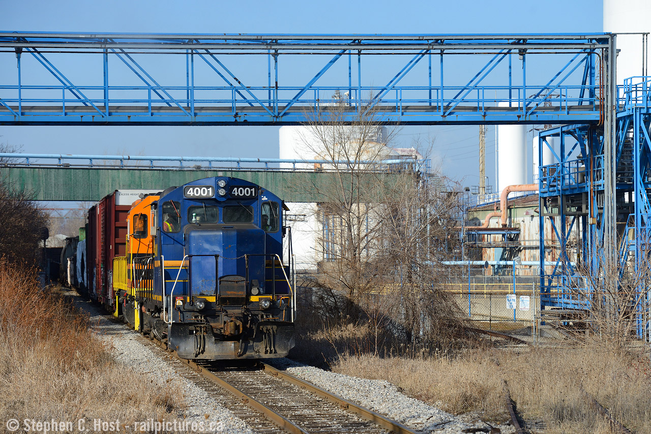 As discussed in my last photo, after shooting  CN 550  I heard SOR call to head down the N&NW Spur so I set up for a shot I've had in mind for a while. You don't exactly know where the SOR is going to go, for example, they could work the Bunge leads instead, but once I heard "RLK 4001 clear on the approach to Irondale" I knew I made the right choice.
Irondale is a curiosity as this location has a long railway history. This location had long ago been a CNR/TH&B interchange point for the Radial and was a stop on the Hamilton Radial Electric Railway. The Hamilton Street Railway also continued to interchange cars here for CNR/TH&B for Firestone until the late 1940's and the name Irondale has stuck to this day as a result. The diamond and signalled crossing is for a CP industrial lead crossing the SOR (CN owned) N&NW spur mainline. For more on Hamilton's interurbans, see this  Andrew Merrilee's article from approx 1950. 
After this I went back to see what CP was up to, and they were lifting a loooong cut of cars at NSC - which is usually the last thing they do before heading back to the yard. So I scoped out a shot and found something new to me. Next photo.