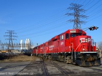 On a beautiful Sunday morning, no trains were coming on the mainline and I had four hours to kill. I decided to go 'fishing' in Hamilton to see what I could find and I was handsomely rewarded, I managed to find CN 550, CP TH31 and a SOR job and just went between all three. Here's the first photo:CP Yard job crossing the SOR at grade by Gage Ave.<br><br>
Track in Hamilton can be confusing, but let me try to help you. This is a CP Kinnear yard job, TH31 crossing at grade with the SOR N&NW Spur, protected by a fully automatic signalling system controlled by SOR Railterm dispatch in Dorval. The train was basically heading in the Northward direction on the Belt line and is arriving to start work. But, this isn't the Belt Line - it's the Beach Branch. If you look behind me you'd see the train crossing Gage Ave twice and the first crossing behind me is where the Beach Branch jct switch is - with the Belt Line continuing beyond Sherman Ave.  The track you see here, The Beach Branch continues alongside the SOR mainline for a mile - and a small Interchange yard (Four tracks in total with CP) and former Dofasco tracks (Disconnected) until after Ottawa St - where it joins CP's Adam's Yard (North side yard) and kind of ends somewhere around there. SOR has a small yard on the south side of Adam's yard also used for CP Interchange. All CP track is ex TH&B and CP retains joint access to just about all spurs that touch the CP's Belt Line and Beach Branch - so if you go fishing, you'll find them almost anywhere. Hope this helps - ask questions anytime  especially you young kids :)