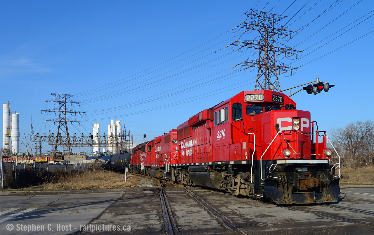 On a beautiful Sunday morning, no trains were coming on the mainline and I had four hours to kill. I decided to go 'fishing' in Hamilton to see what I could find and I was handsomely rewarded, I managed to find CN 550, CP TH31 and a SOR job and just went between all three. Here's the first photo:CP Yard job crossing the SOR at grade by Gage Ave.
Track in Hamilton can be confusing, but let me try to help you. This is a CP Kinnear yard job, TH31 crossing at grade with the SOR N&NW Spur, protected by a fully automatic signalling system controlled by SOR Railterm dispatch in Dorval. The train was basically heading in the Northward direction on the Belt line and is arriving to start work. But, this isn't the Belt Line - it's the Beach Branch. If you look behind me you'd see the train crossing Gage Ave twice and the first crossing behind me is where the Beach Branch jct switch is - with the Belt Line continuing beyond Sherman Ave.  The track you see here, The Beach Branch continues alongside the SOR mainline for a mile - and a small Interchange yard (Four tracks in total with CP) and former Dofasco tracks (Disconnected) until after Ottawa St - where it joins CP's Adam's Yard (North side yard) and kind of ends somewhere around there. SOR has a small yard on the south side of Adam's yard also used for CP Interchange. All CP track is ex TH&B and CP retains joint access to just about all spurs that touch the CP's Belt Line and Beach Branch - so if you go fishing, you'll find them almost anywhere. Hope this helps - ask questions anytime  especially you young kids :)