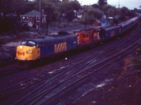 As dusk descends, VIA train No. 1 arrives in Sudbury behind ex-CP FP9 1410, CP GP9 8519, and former CP E8A 1899 (previously the 1802). VIA's combined operations are evident with the mixing of former CN and CP passenger cars. "The Canadian" originated at Montreal's Central Station before regaining the traditional Canadian Pacific route at Dorval. It will follow CP tracks until the outskirts of Winnipeg where it will switch to CN lines and ise Winnipeg Union Station.