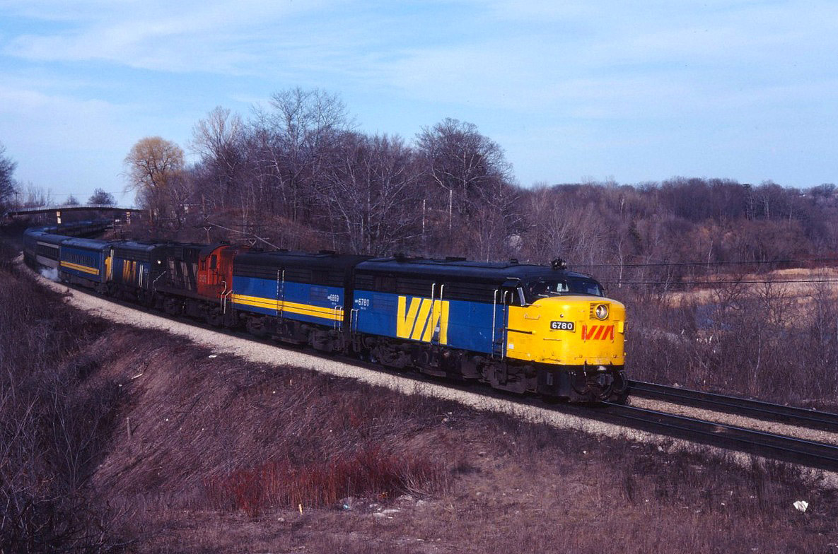 VIA 75 was a popular train to catch--both for railfans and customers! In the 1970s and 1980s, it often had three or four units and 15 or more cars...such was the demand for a late afternoon departure to London and Windsor. Today we have FPA4 6780, FPB4 6869, leased CN RS18 3126, and an unidentified FP9 leading the train under the Plains Road bridge into Bayview.