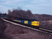 VIA 75 was a popular train to catch--both for railfans and customers! In the 1970s and 1980s, it often had three or four units and 15 or more cars...such was the demand for a late afternoon departure to London and Windsor. Today we have FPA4 6780, FPB4 6869, leased CN RS18 3126, and an unidentified FP9 leading the train under the Plains Road bridge into Bayview.