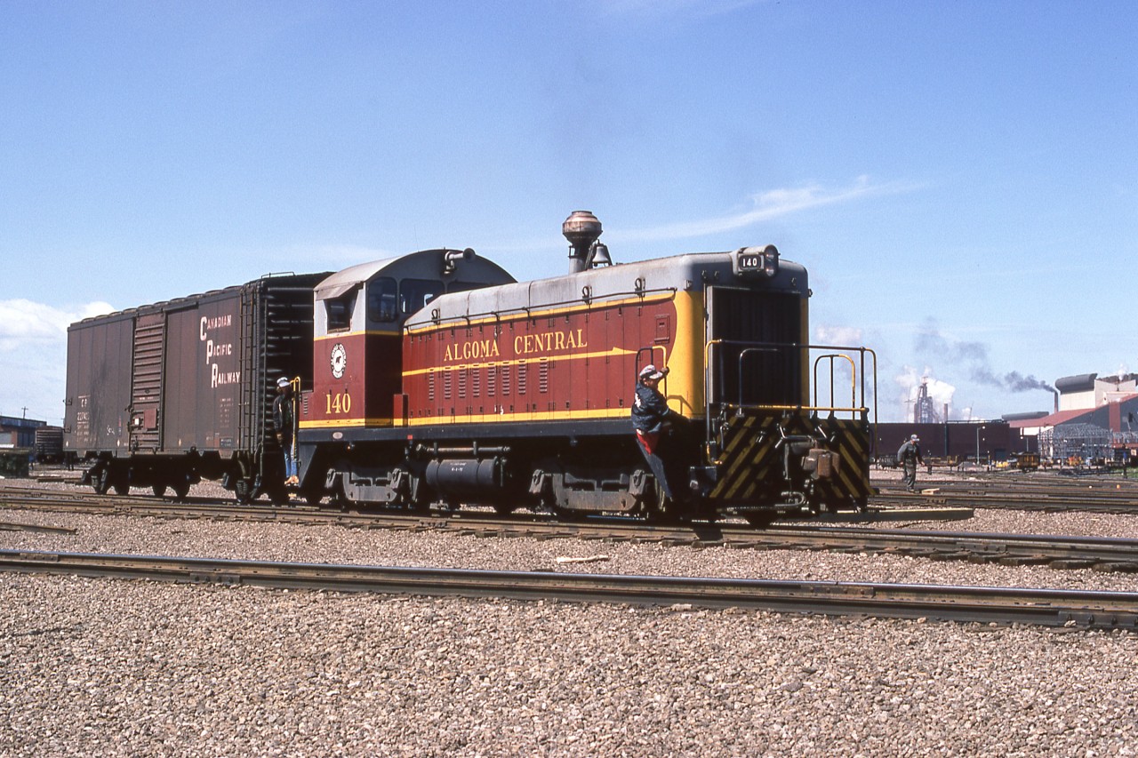 Algoma Central 140 has a CP boxcar in tow as it works in Sault Ste. Marie, Ontario on June 12, 1974.