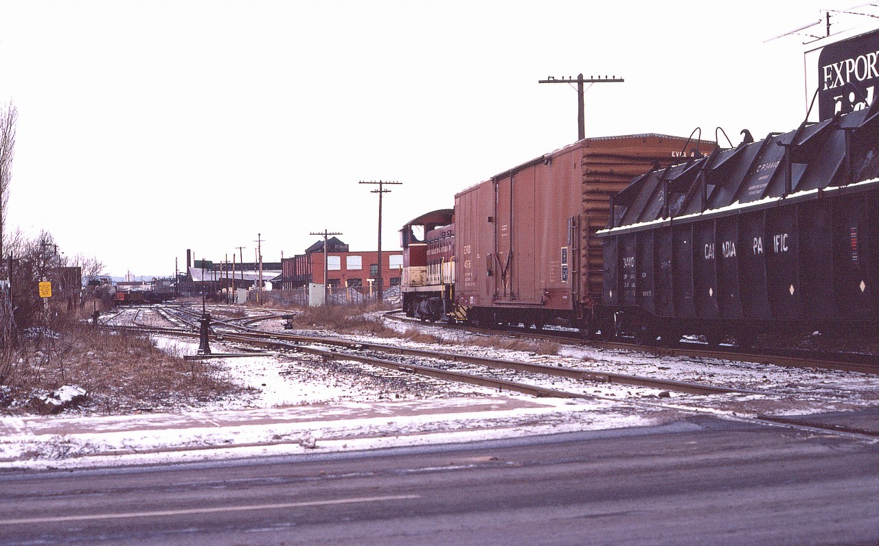 TH&B SW-9 56 swings onto the Beach Branch of the Hamilton Belt Line with a drag for Adams Yard on December 29, 1977. Fisher Yard can be seen in the distance at the left.