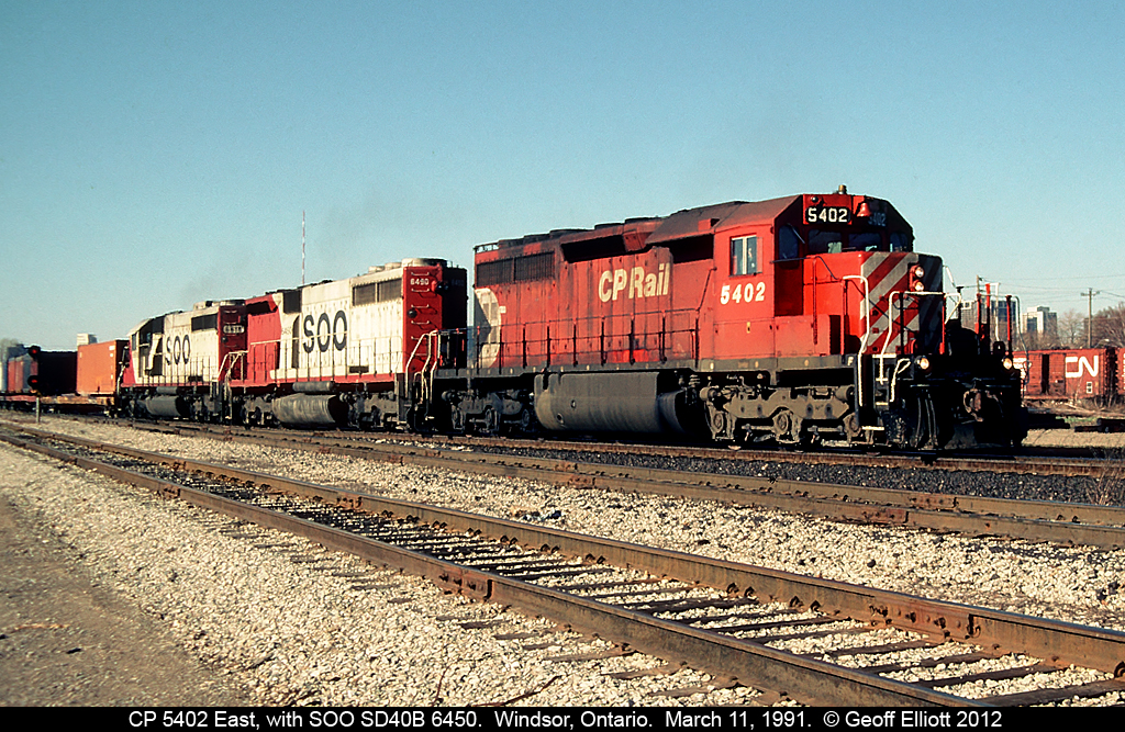 A different kind of "A-B-A" set of power on CP 502 tonight.  CP 5402 leads one of a kind SOO Line SD40B #6450 and SOO Line 6618 as they crest the top of the hill after having come into Canada via the Detroit River Tunnel.  Photo taken at Windsor South on March 11, 1991.