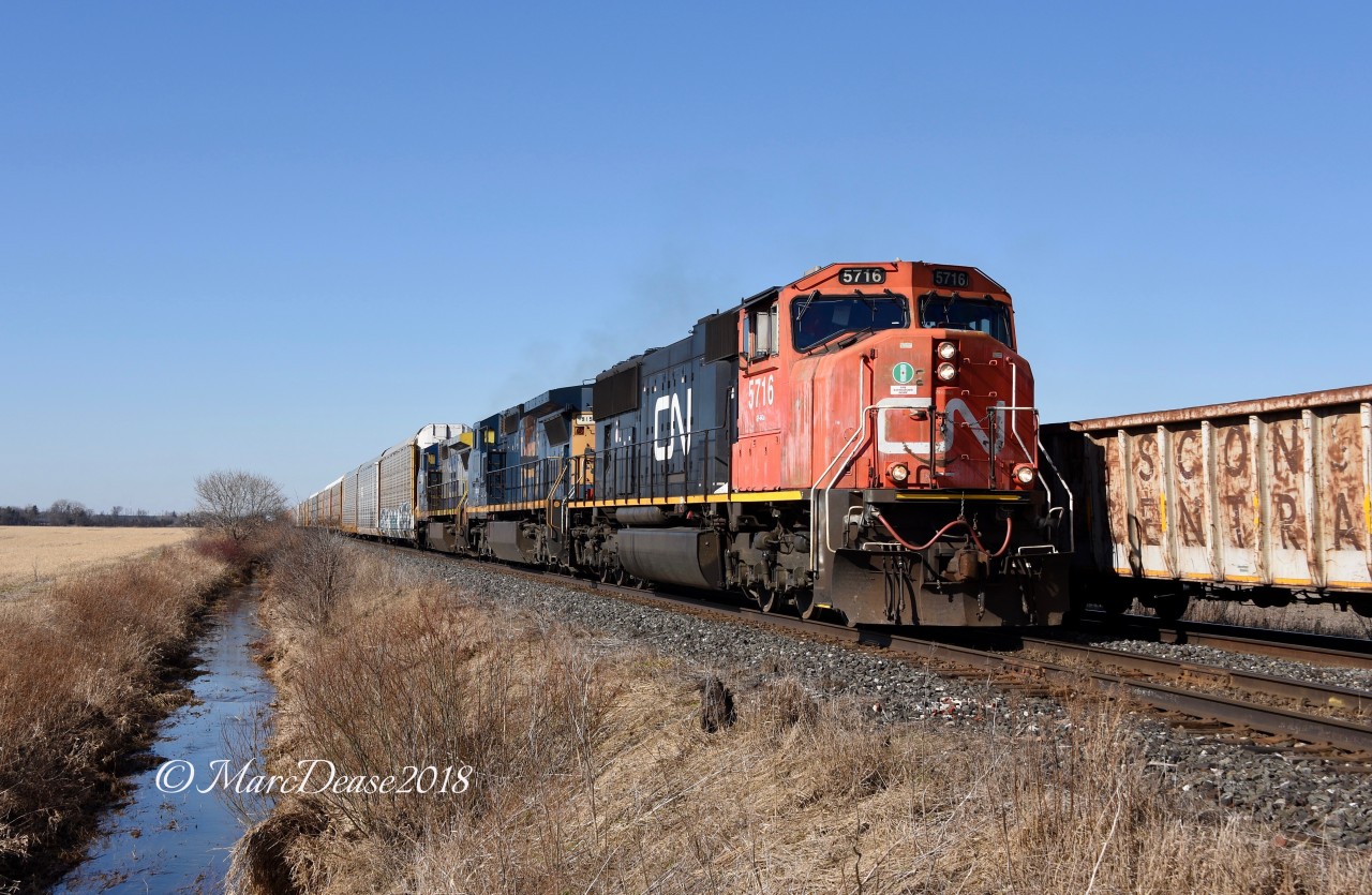 CN 5716 with GECX 9150 and GECX 7354 meet train 385 at Waterworks Sideroad east of Sarnia, ON.