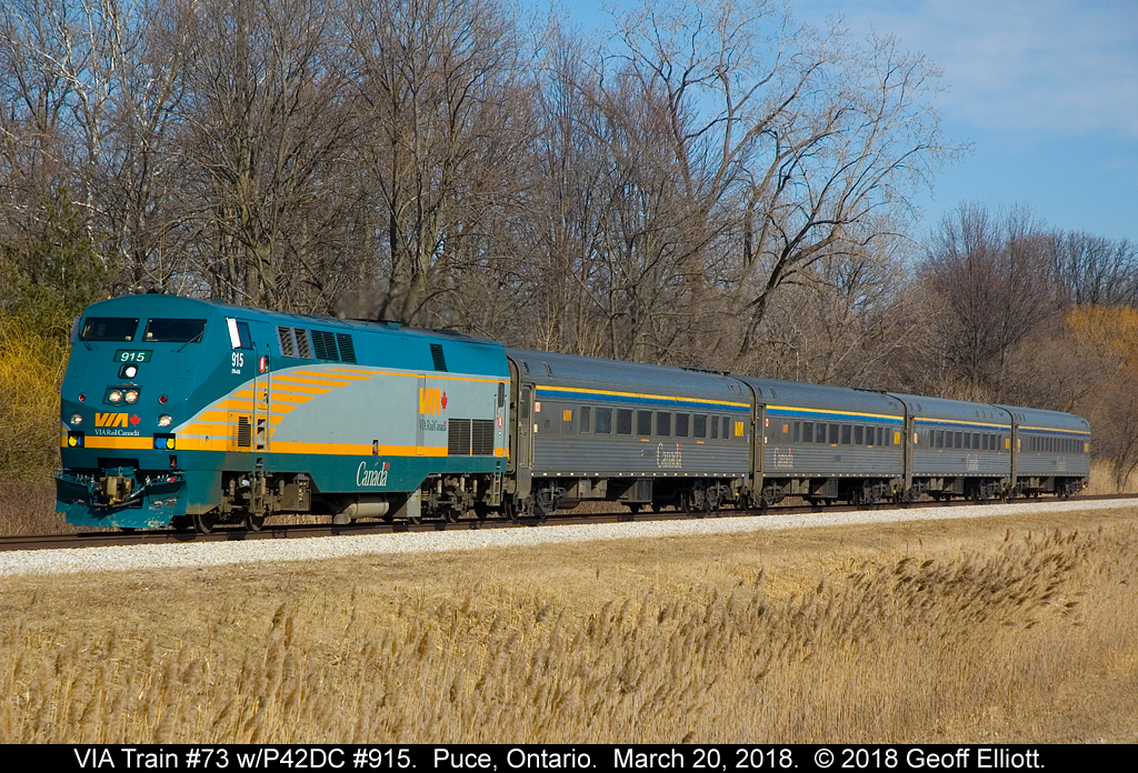 VIA 915 heads up a nice matched stainless consist on train #73 as it rolls through Puce, Ontario on March 20, 2018.