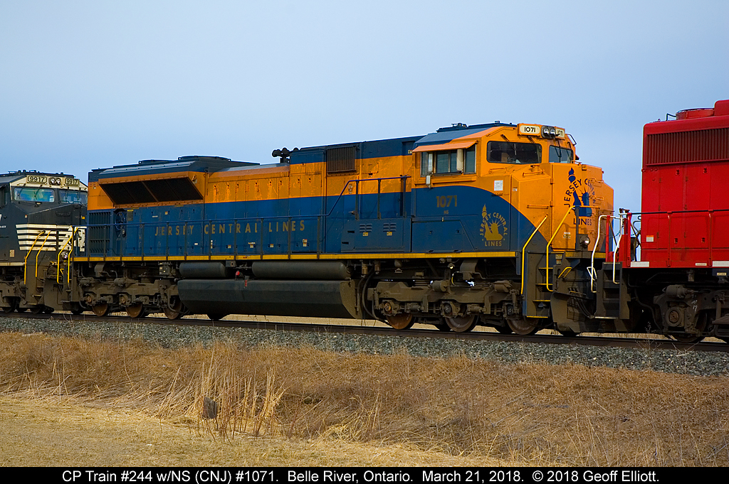 Thanks to a H/U via Earl Minnis from Mike Harding late the night before that 244 was leaving Elkhart with the NS 1071 leading. This gave me some motivation to watch what was going on this morning. After tracing as in Windsor @ 0800 I figured I'd have a chance.  Here is NS 1071 in it's Jersey Central Railroad heritage scheme, mid-consist now behind CP 3033, looking a little worn for wear and needing a bath.  The sun peaked out just long enough to shed a little light on the subject to help. That's another NS Heritage I can cross off the list.