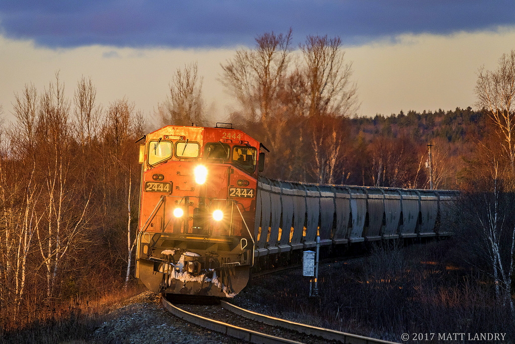 With the last bit of light, CN 2444 leads westbound train 406 as they round the bend at Rothesay, New Brunswick. Moments after the train passed, the sun dipped below the horizon for another day.