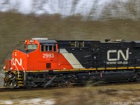 Panning CN 2993 westbound, with a few flurries starting to fall. 