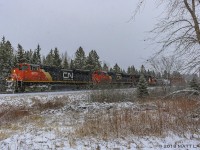 CN 8873 leads a westbound mixed freight, as they rumble through Passekeag, New Brunswick, during a snowstorm. 