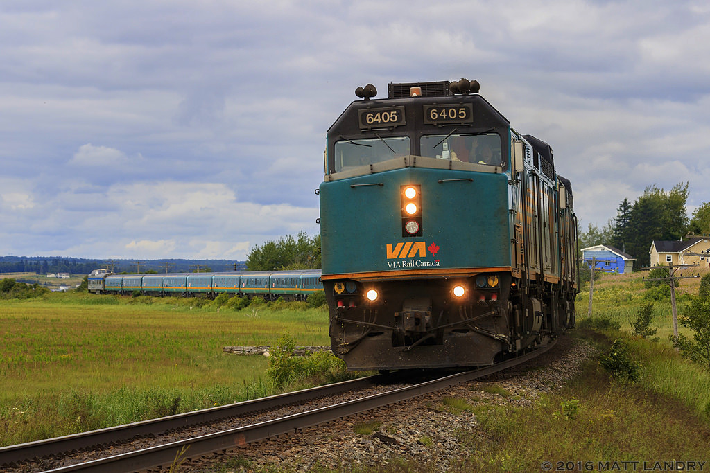 With a wave from the friendly crew, VIA 14 is eastbound, rounding the S-Curve at Upper Dorchester, New Brunswick.