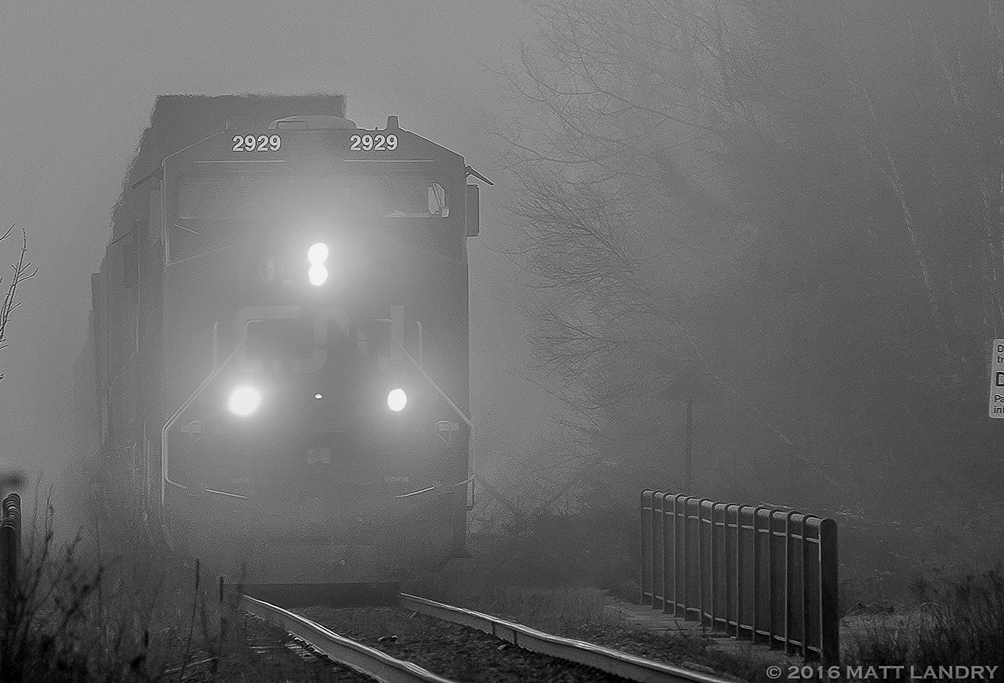 On a foggy Spring morning, CN 2929 leads train Q121, blasting through the fog at Berry Mills, New Brunswick. I don't do a great deal of black and white photos, but I thought maybe the mood of the photo lends itself to an attempt at something black and white.