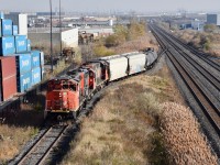 CN local (most likley 559) is seen switching on to the Consumer Glass Spur in Brampton. They have 2 hoppers to drop off at the Consumer Glass Plant which is at the end of this line and they will lift about 10 hoppers from the plant. The 2 tank cars will later on be dropped off at the Textile Rubber and Chemicals Plant on the Brampton Industrial Spur and 2 tank cars will be lifted from them as well. 