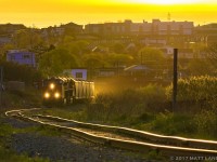 The tracks over to CN's Courtnay Bay yard are in rough shape. At sunrise, CN B730 slowly negotiates it's train around the "rock cut" and are on the move to set off the cars at Courtnay Bay to be unloaded. The tail end of the train is still in CN's Island Yard, blocking crossings with their slow journey over. 