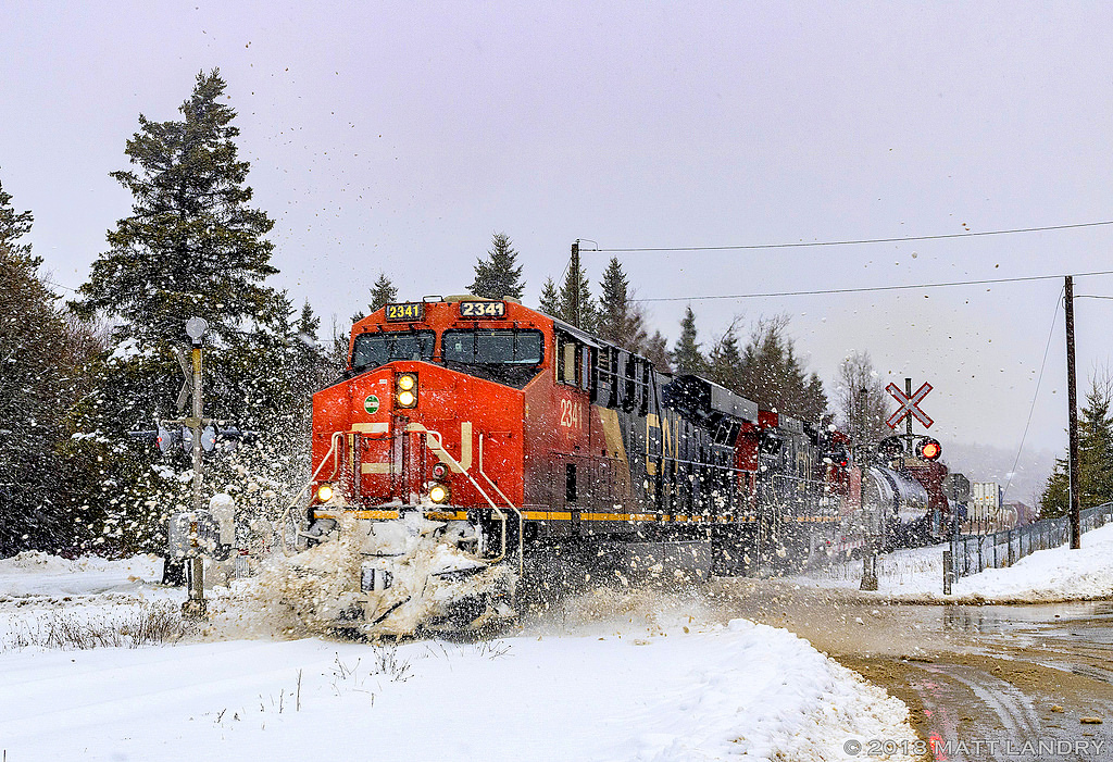 The day after a 30cm snowfall in Southern New Brunswick, CN 2341 leads train 406, as they hit a small snow pile, approaching Saint John, New Brunswick.