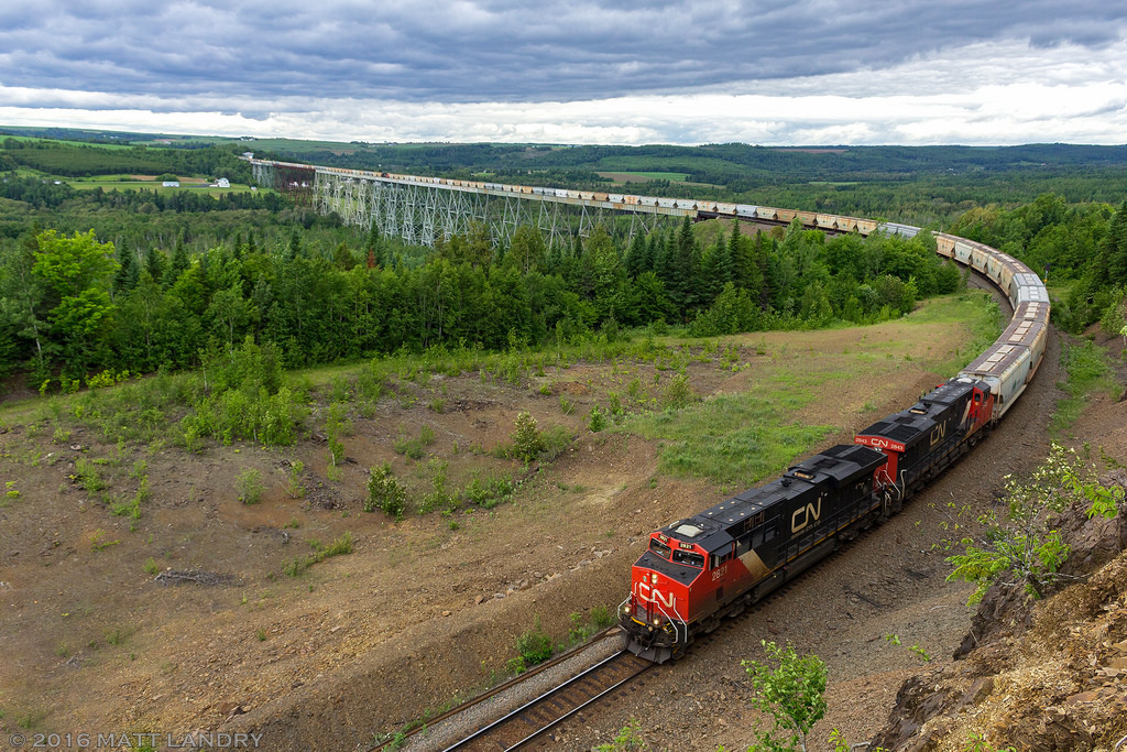 After an hour hike two and from, a 3 hour wait, and a busted camera, a CN eastbound potash train rounds the bend after crossing the massive Salmon River Trestle. This is a new vantage point for me. Was worth the trek.