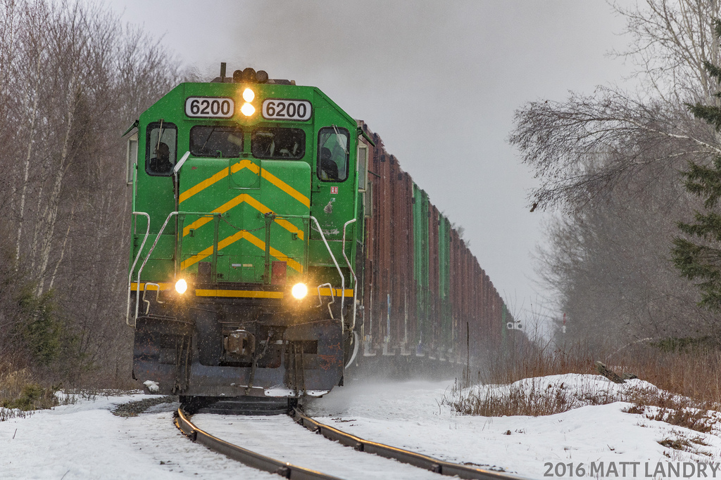 After setting off a "pole car" at Fredericton Junction, NBSR 6200 continues on it's way out of the Jct, approaching Tracy, New Brunswick, as the snow starts to fall.