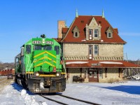 NBSR 6318 leads a New Brunswick Southern Railway westbound freight, as they pull by the famous railway station at McAdam, New Brunswick. They crew will pull ahead, set off a couple of cars in the yard. Then a new crew will take over and bring the train westward into Maine. 