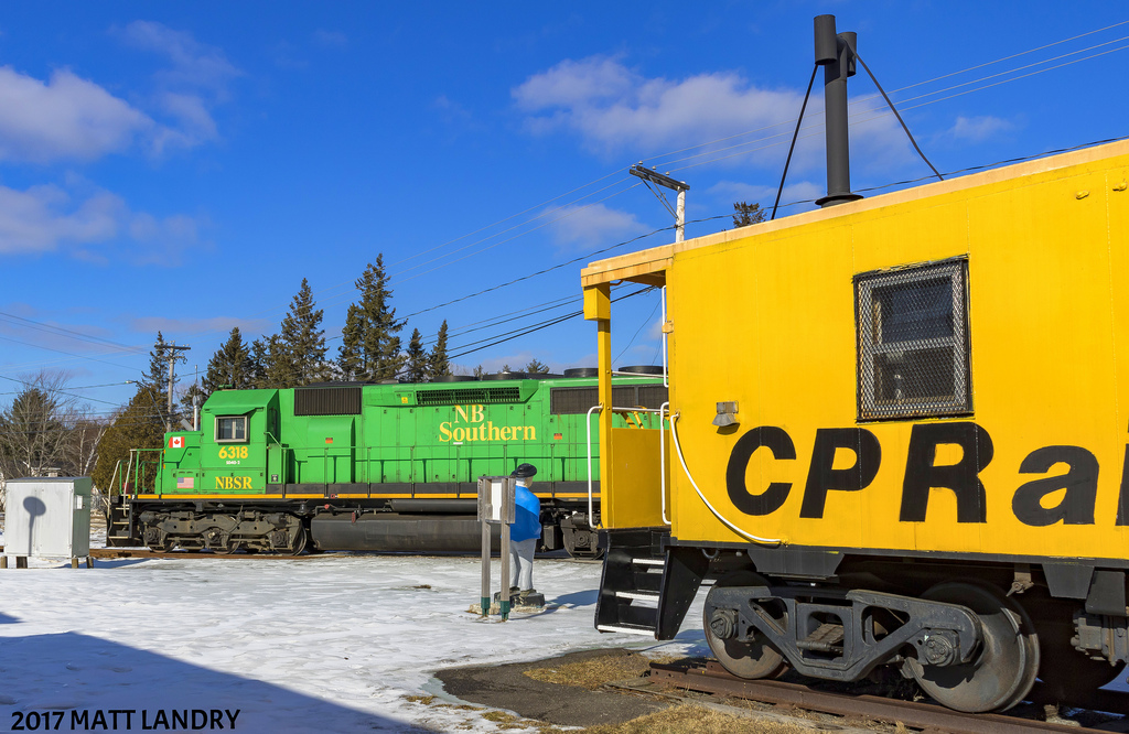 NBSR 6318 does a reverse movement to do a set off and pick up of a car at the now "Fredericton Junction Spur". Back when CP & CN ran full tilt in New Brunswick, this track here at Fredericton Junction ran northbound to Fredericton. I believe the last CP train to run up into Fredericton was somewhere in the early/mid 90's. It's a shame for sure.